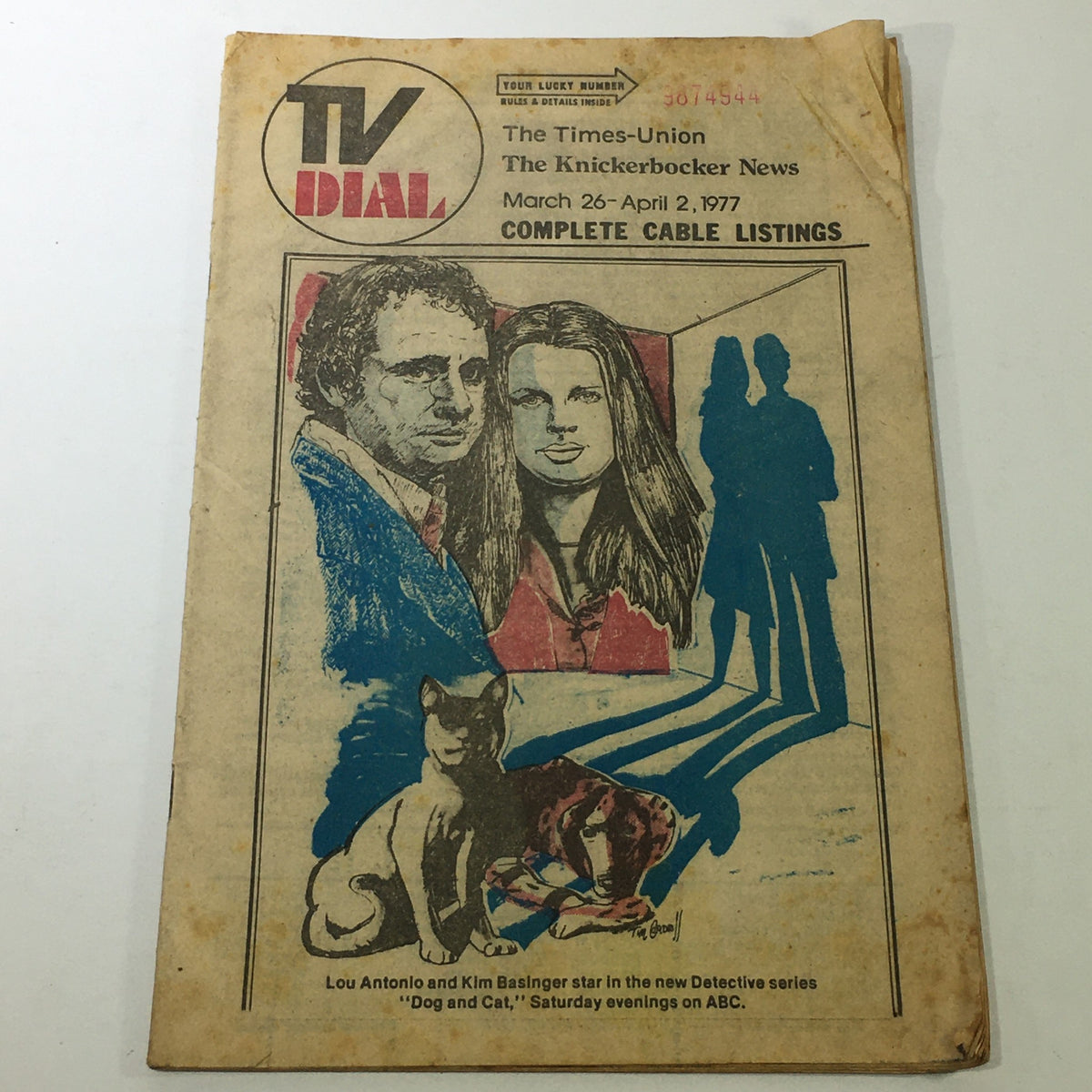Vintage TV Dial from The Knickerbocker News Times Union, dated March 26-April 2, 1977, featuring illustrated portraits and a cat on the cover, showcasing complete cable listings of the era.