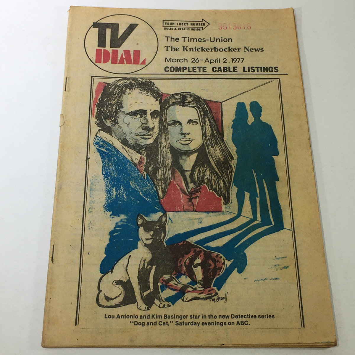 VTG TV Dial Complete Cable Listings March 26-April 2 1977 featuring a colorful illustration of two characters and a cat, promoting the 'Dog & Cat' series.