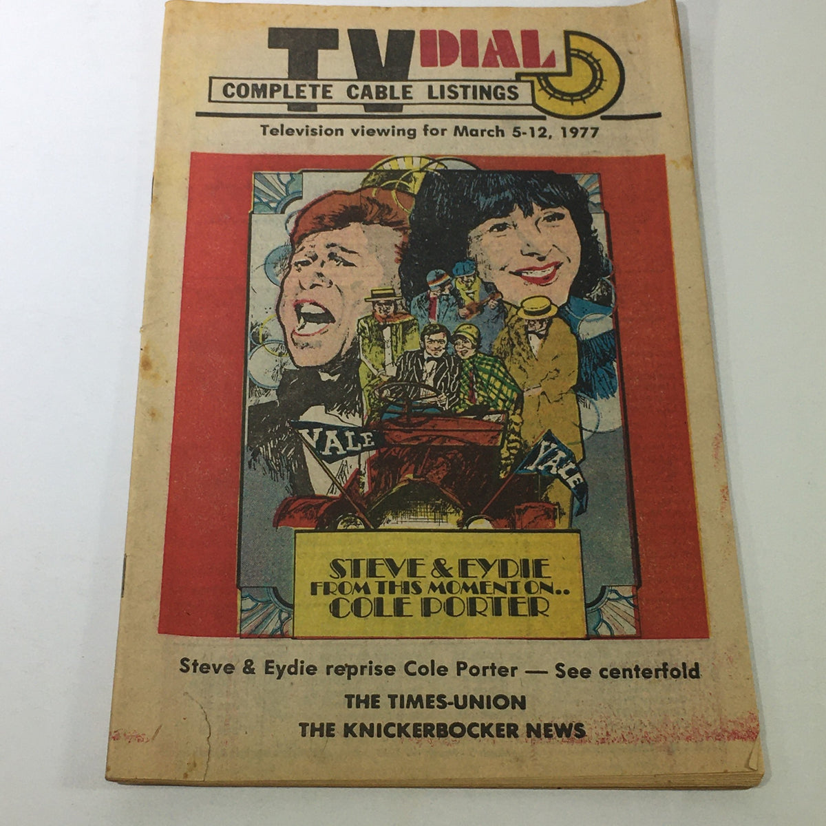 Vintage TV Dial Complete Cable Listings from March 5-12, 1977, featuring Steve & Eydie while highlighting Cole Porter, with vibrant illustrations and details on television programming. Ideal for collectors of retro television memorabilia.