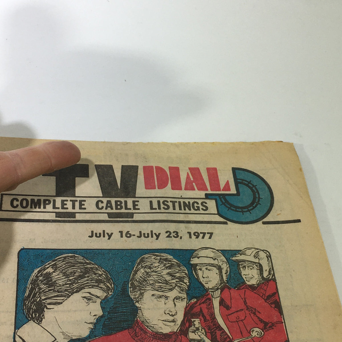 Close-up view of the VTG TV Dial Complete Cable Listings July 16-23 1977 magazine cover, highlighting the title and illustrations of characters and scenes from classic television.
