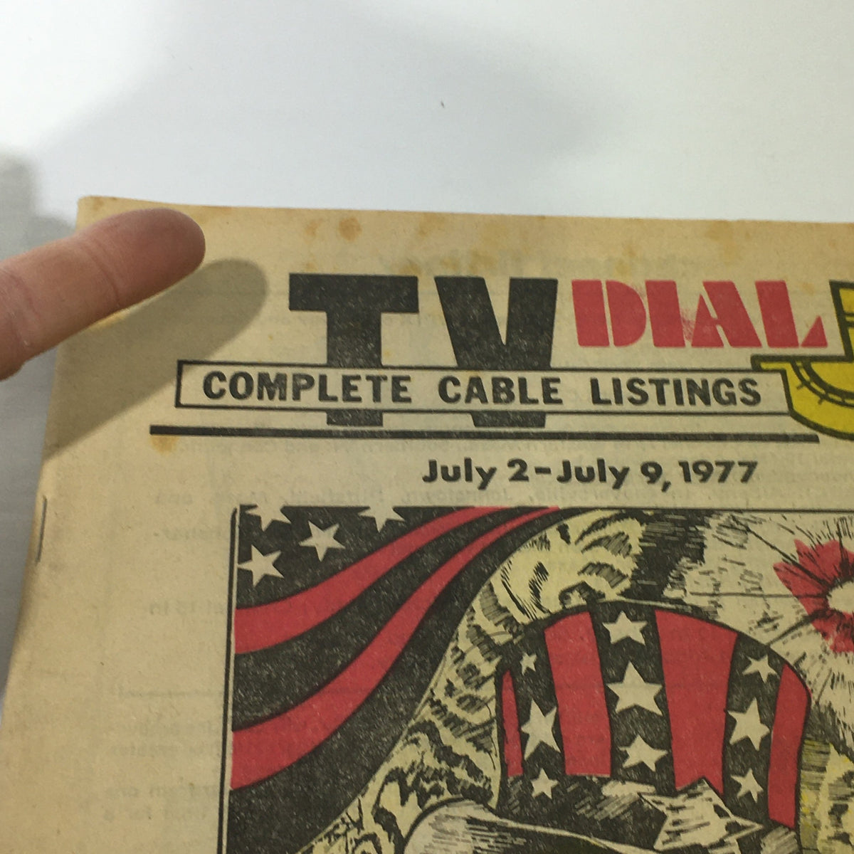Close-up of the VTG TV Dial Complete Cable Listings July 2-9 1977 cover, showcasing the bold title and star-spangled design.