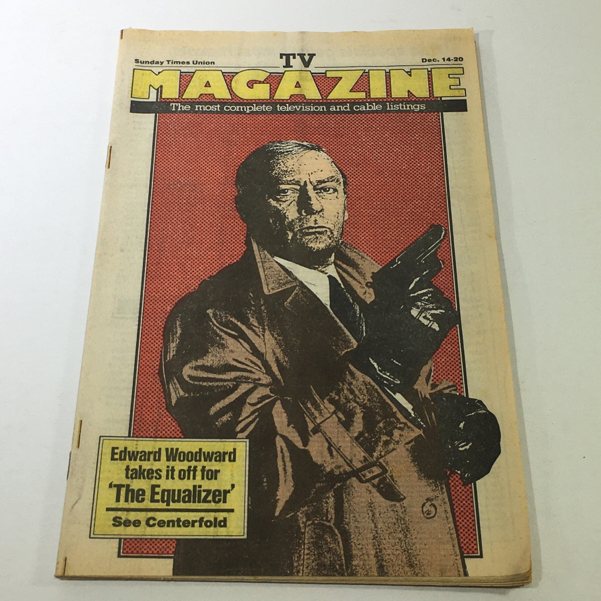 Cover of VTG TV Magazine: December 14-20 1986 featuring Edward Woodward from 'The Equalizer', depicting him prominently in a trench coat with a gun, highlighting the magazine's focus on 1980s television history.