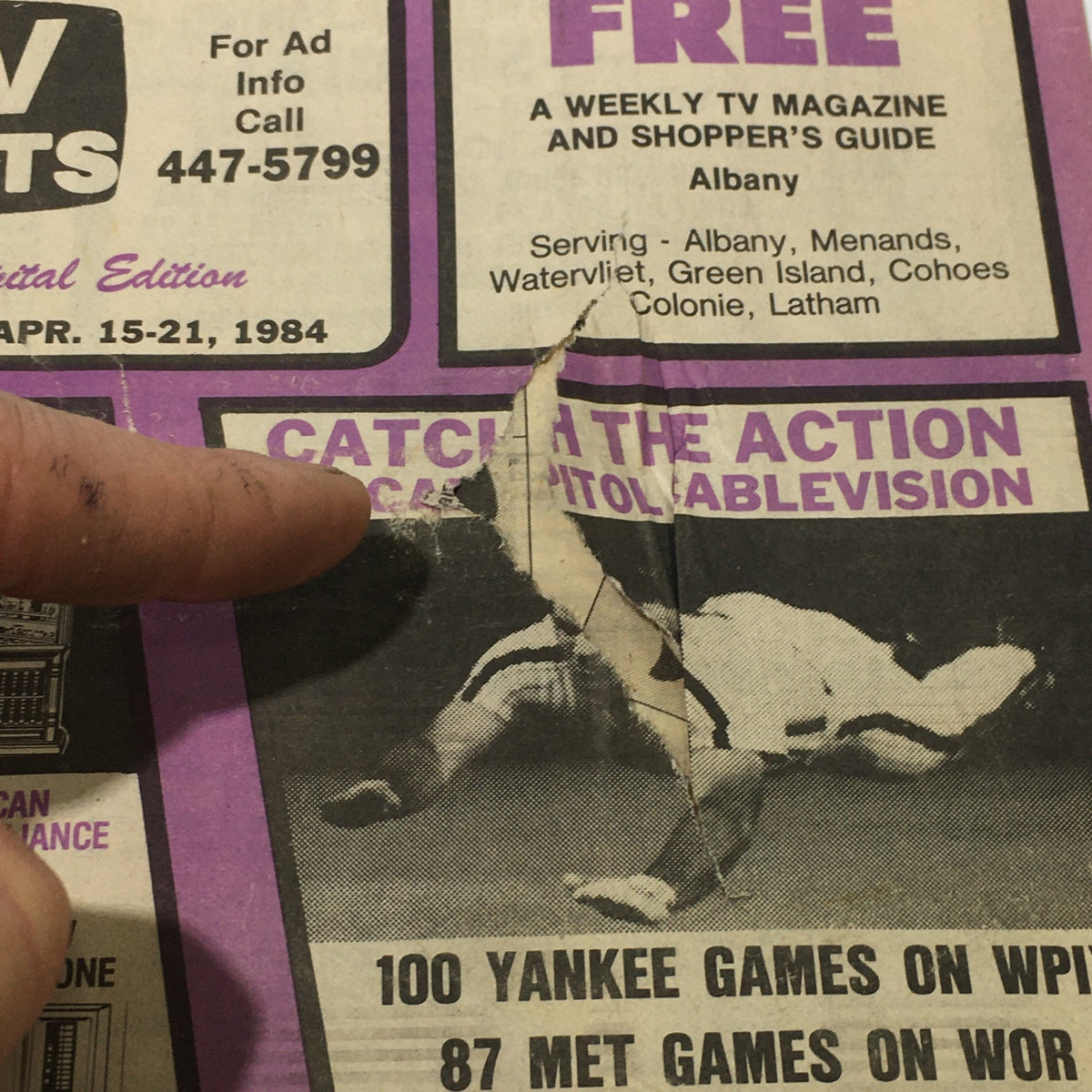 Detail view of a section on the front cover of TV Facts Magazine, showcasing TV listings and an advertisement for Capitol Cablevision from April 15-21, 1984.