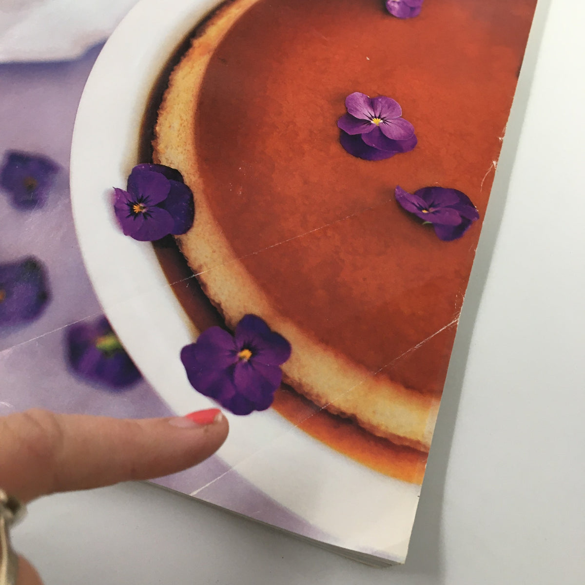 Close-up detail of the dessert on the cover of Gourmet Magazine April 2000, showing violets on a cheesecake.