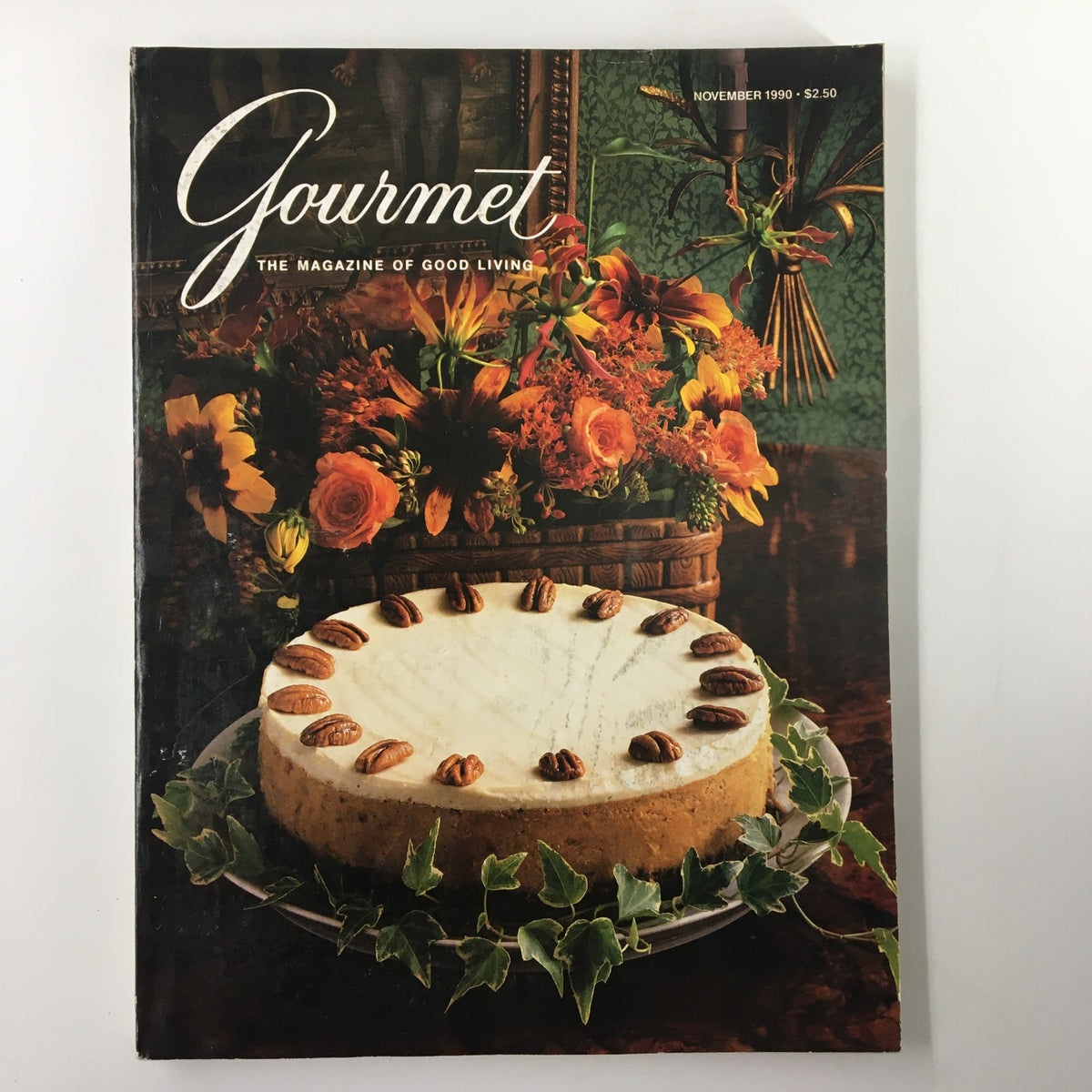 Cover of Gourmet Magazine November 1990 featuring a Pumpkin Cheesecake with Bourbon Sour Cream, surrounded by vibrant fall flowers, capturing the essence of Thanksgiving and seasonal recipes.