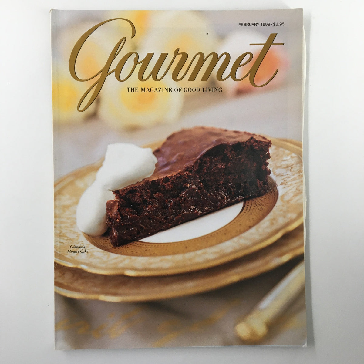 Cover of Gourmet Magazine February 1998 featuring a Gianduja Mousse Cake with whipped cream, showcasing gourmet culinary themes.