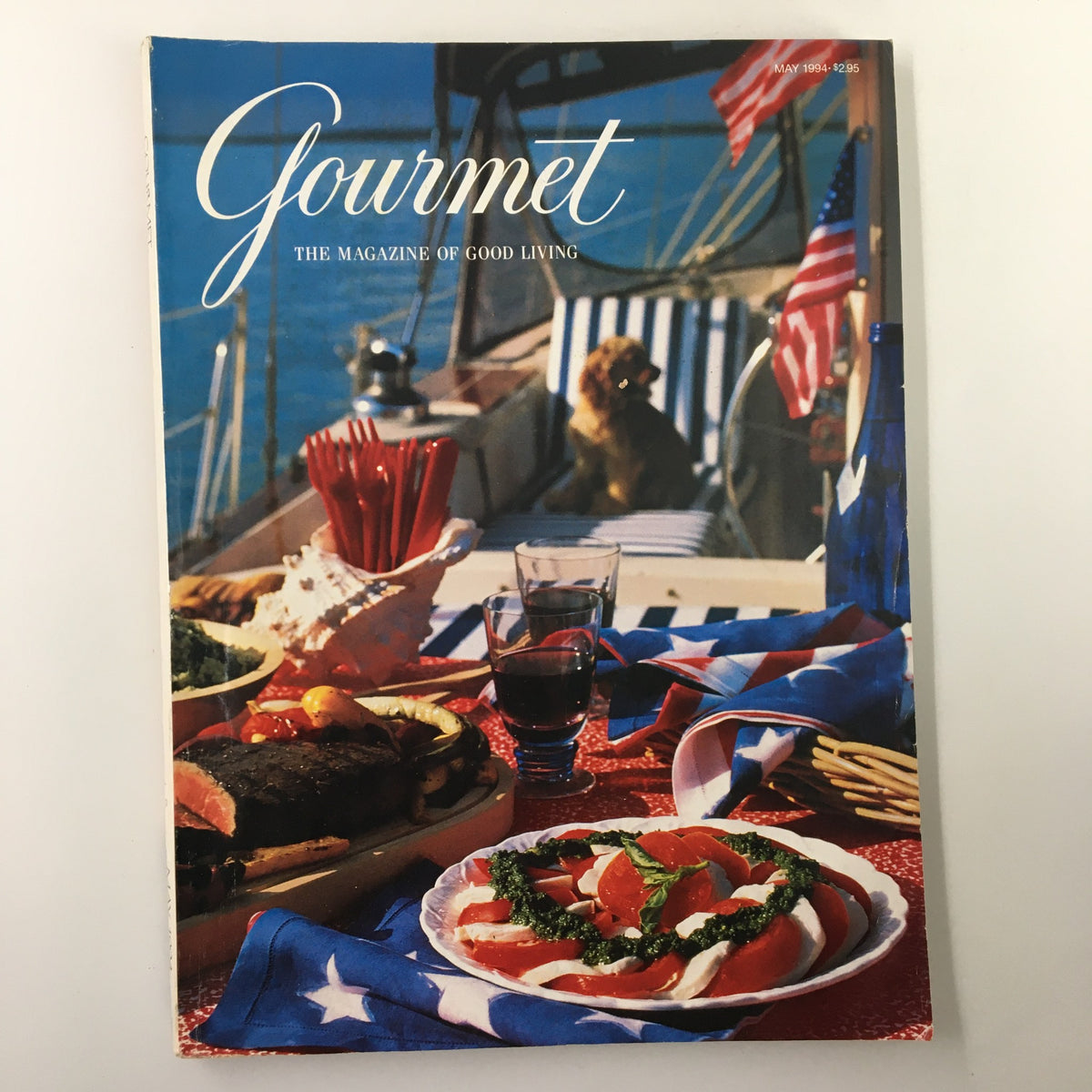 Gourmet Magazine May 1994 cover showcasing a vibrant outdoor dining scene with a flag-themed table setting featuring summer dishes and drinks.