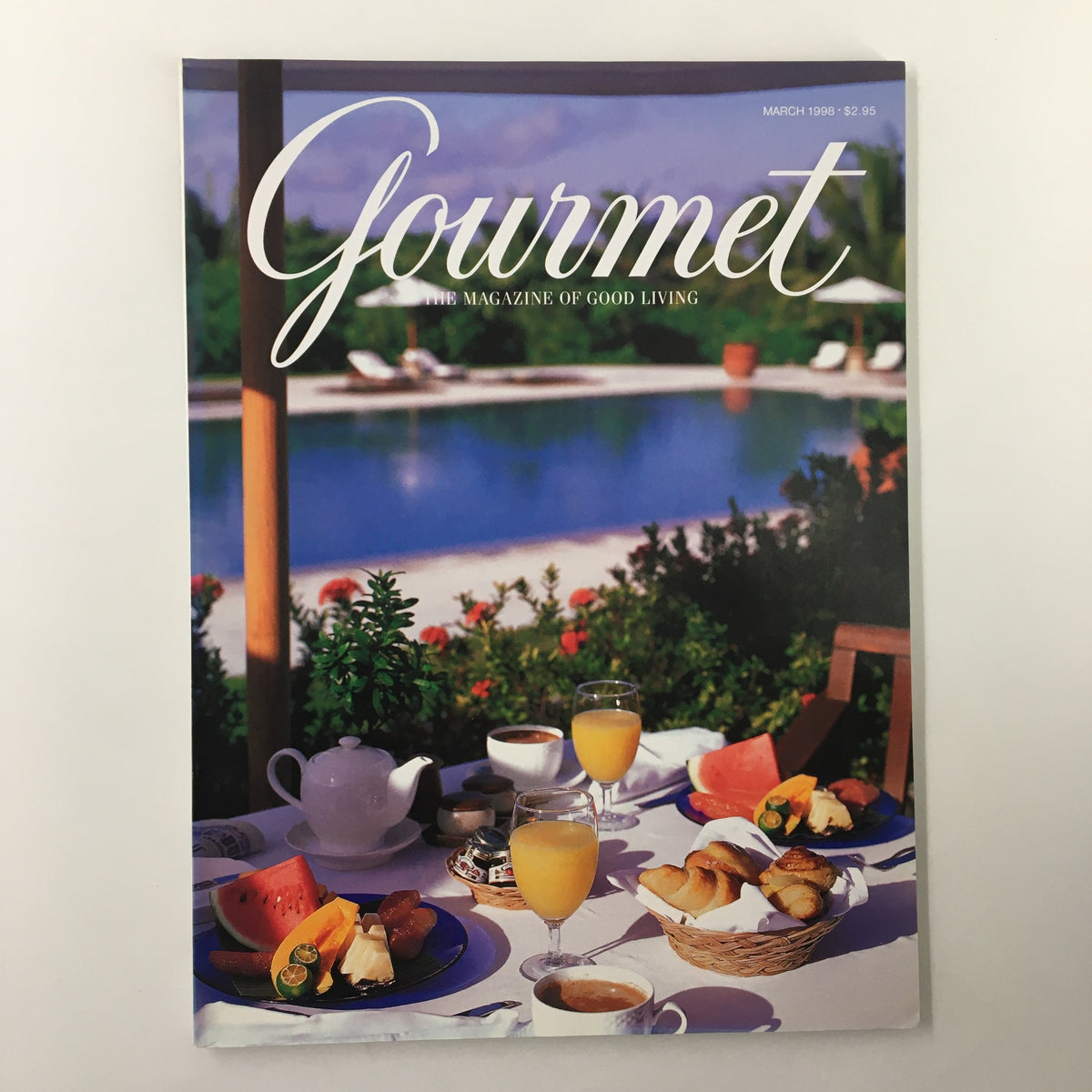 Cover of Gourmet Magazine March 1998 featuring a luxurious breakfast setting by a pool, highlighting Hideaway Resorts of the Philippines.