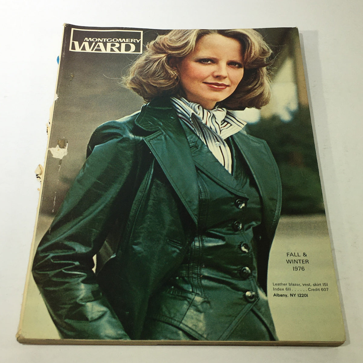 VTG Montgomery Ward Store Guide Catalog Fall & Winter 1976 featuring a model in a stylish leather outfit with a blazer, vest, and skirt, showcasing Wards Finest Clothes.