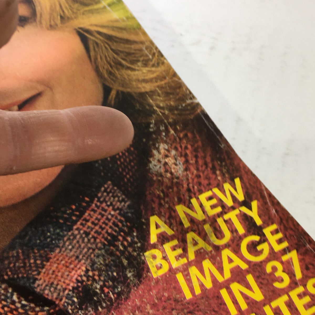 Close-up of the VTG Glamour Magazine September 1975 featuring an article titled 'A New Beauty Image in 37 Minutes' with a finger pointing at the text.