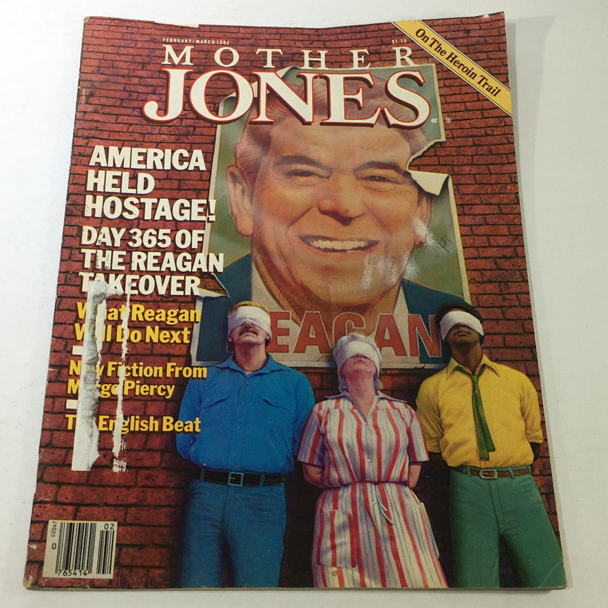 Cover image of Mother Jones Magazine, February-March 1982, featuring the headline 'America Held Hostage!' and a depiction of three individuals with blindfolds in front of a large image of Ronald Reagan.