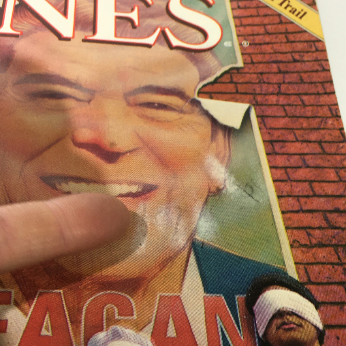 Close-up of the cover of Mother Jones Magazine, February-March 1982, focusing on the image of Ronald Reagan, highlighting the worn edges and details of the magazine's design.