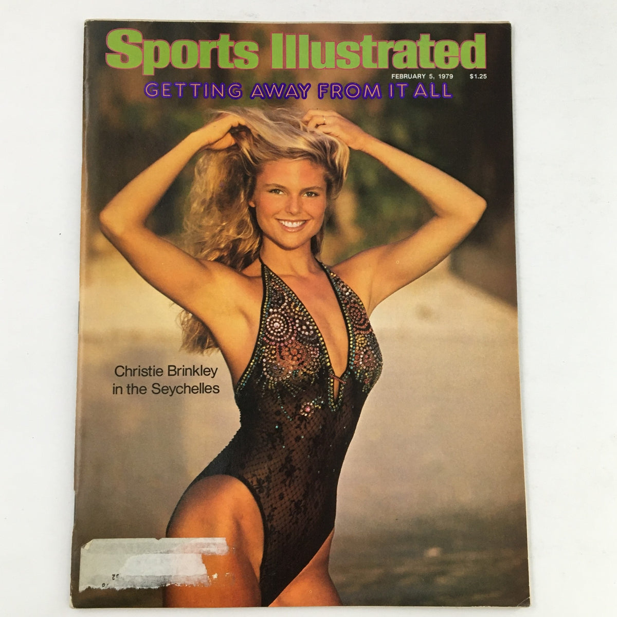 Cover of Sports Illustrated Swimsuit Issue February 5, 1979 featuring Christie Brinkley, posing in a black swimsuit against a tropical Seychelles backdrop.