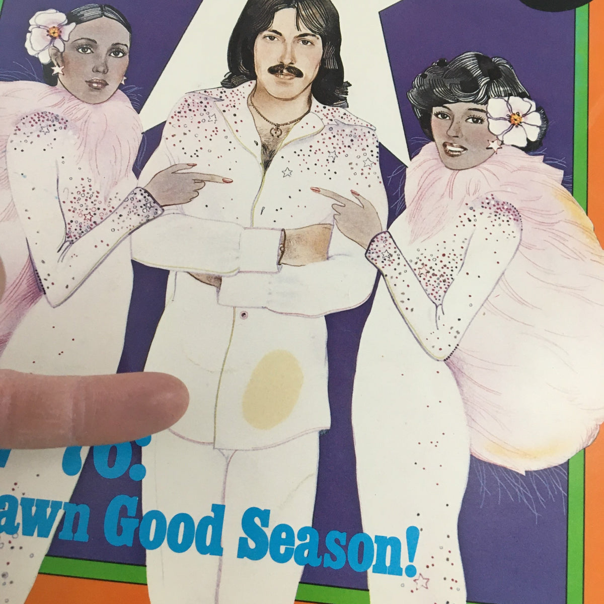 Close-up of the cover of Vintage Dynamite Magazine #16, showcasing the central figure and two characters adorned in sparkly outfits, emphasizing the title 'A Dawn Good Season!'