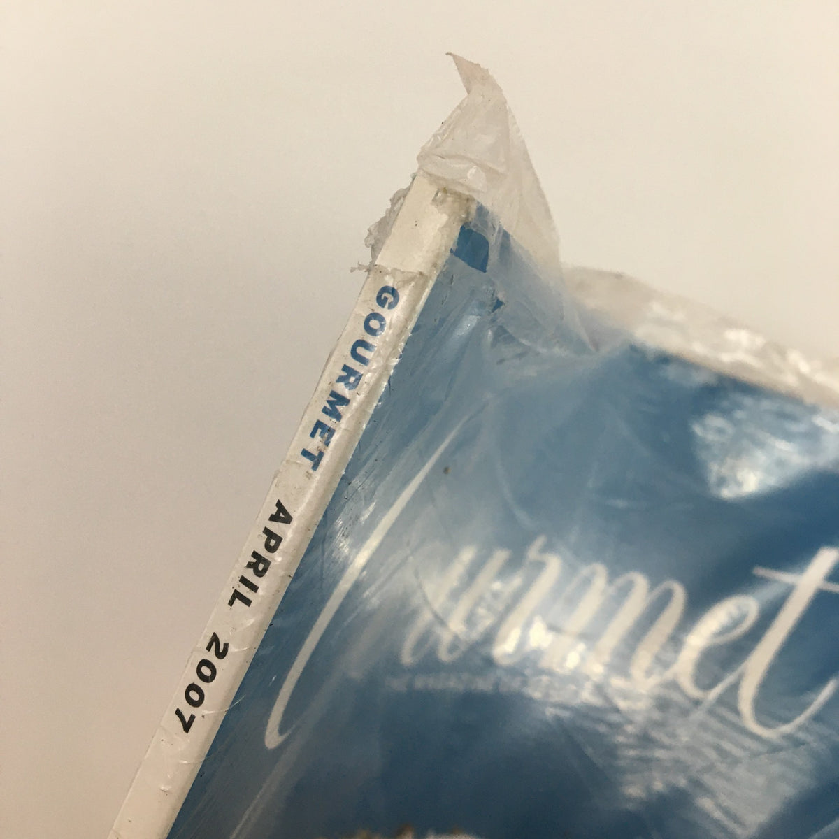 Close-up of the spine of Gourmet Magazine, April 2007, showcasing the title and date. The magazine is sealed in plastic, highlighting its new condition.