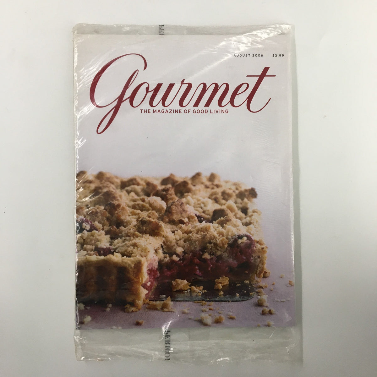Gourmet Magazine August 2006 cover featuring a blueberry yogurt pie recipe, showcasing a delicious pie with a crumbly topping, in plastic wrap.