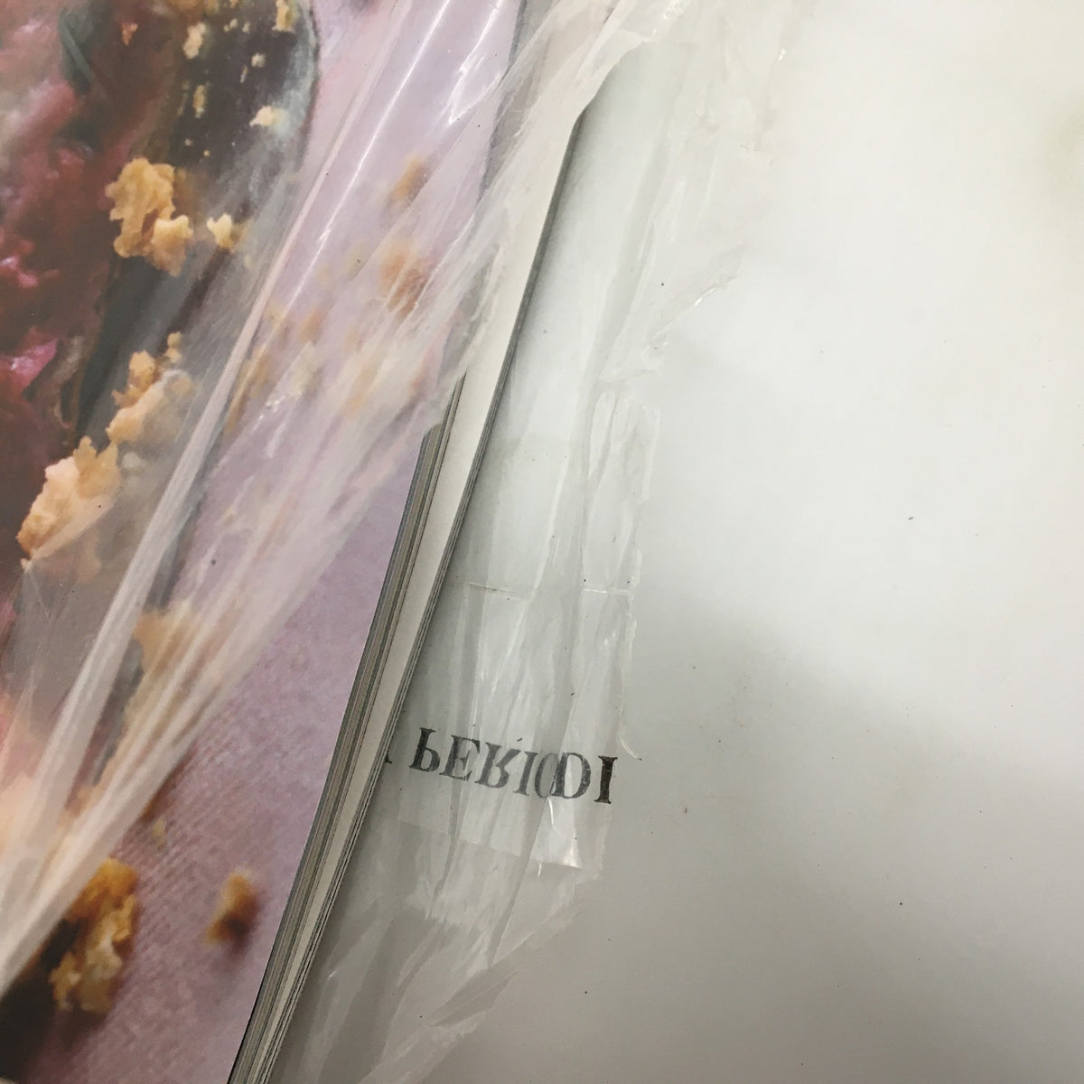 Interior shot of the Gourmet Magazine August 2006, revealing a glimpse of the Blueberry Yogurt Pie recipe page, along with the original plastic cover and minor wear.