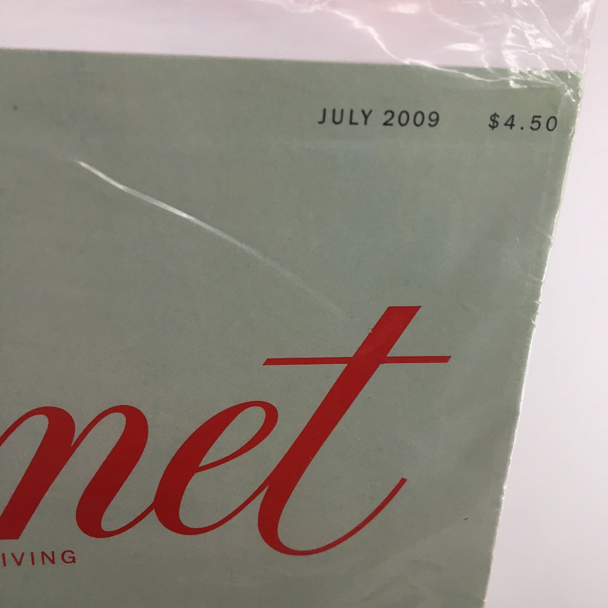 Close-up of the Gourmet Magazine July 2009 date and price, highlighting the unique features of the publication sealed for preservation.