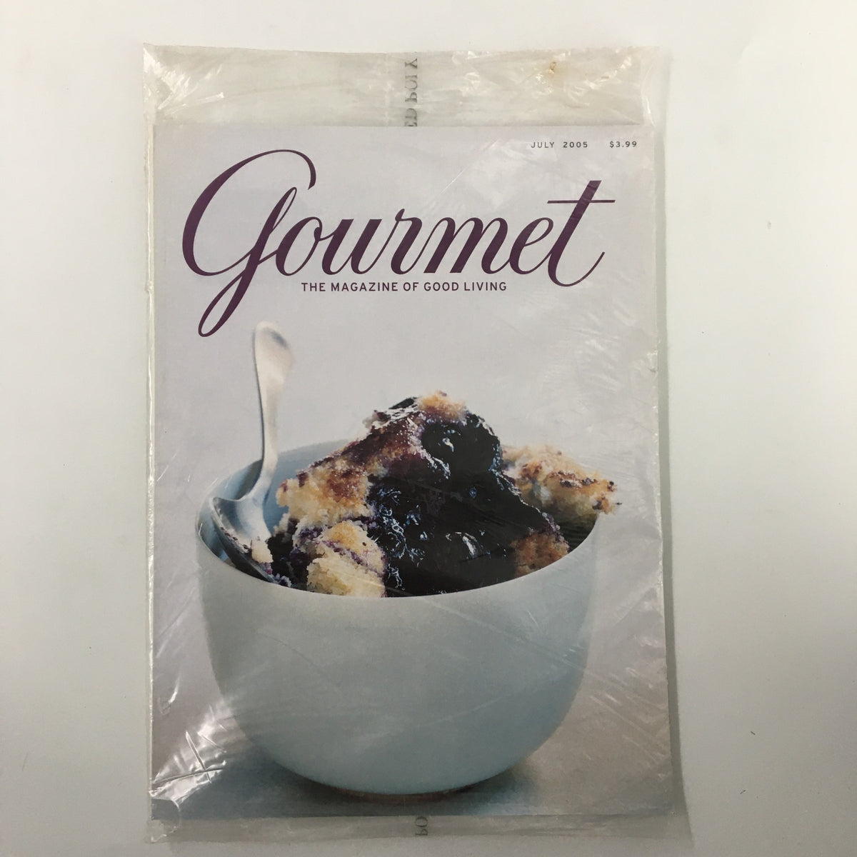 Gourmet Magazine July 2005 cover featuring a delicious blueberry cake, perfect for summer. Encased in original plastic, this vintage magazine showcases vibrant recipes and culinary art.