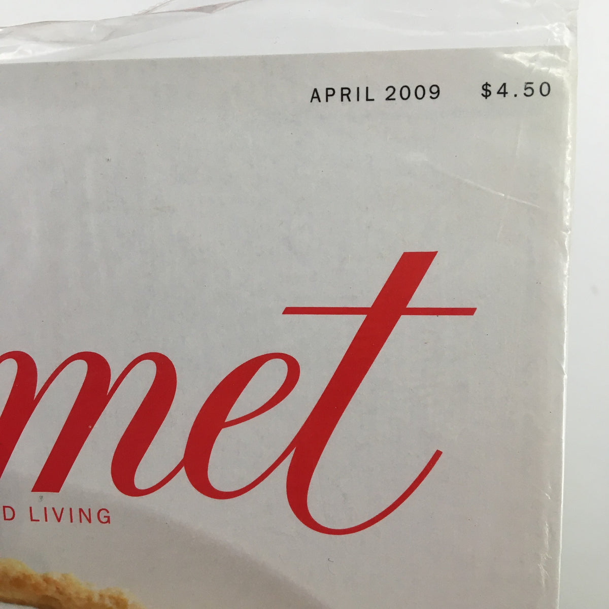 Close-up view of the seal on the Gourmet Magazine April 2009 issue, displaying the publication date and price. The magazine includes a recipe for a Strawberry Mascarpone Tart with Port Glaze.