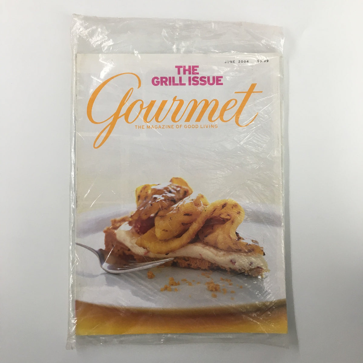 Gourmet Magazine June 2004 cover featuring Grilled Pineapple Tart with Raspberries Cream, sealed in plastic for collectors.