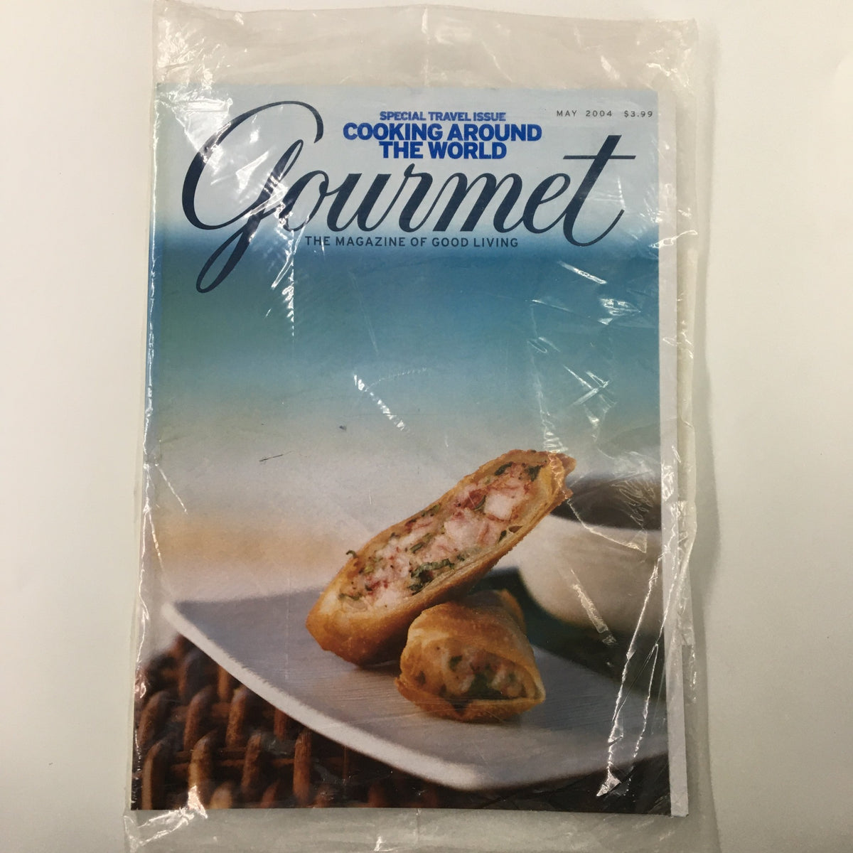 Cover of Gourmet Magazine May 2004 featuring Tropical Spring Rolls with Chile Sauce, showcasing vibrant photography and gourmet cooking themes.