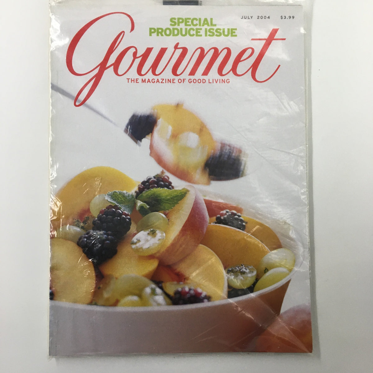 Cover of Gourmet Magazine July 2004, featuring a colorful fruit salad and the title 'Gourmet, The Magazine of Good Living' with a focus on the Mint Granita All-Produce Issue.