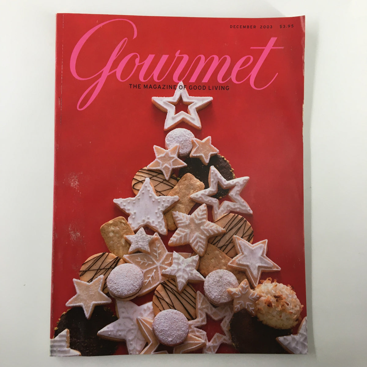Cover of Gourmet Magazine December 2003 featuring a holiday-themed display of decorated cookies and a Christmas tree made of baked goods. This issue highlights travel in Barcelona and culinary delights.