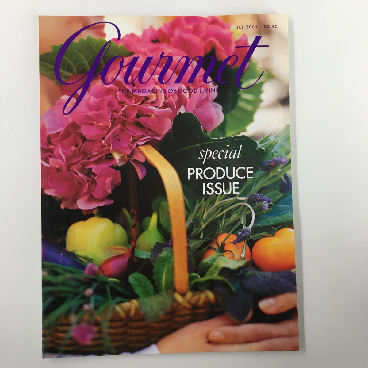 Cover of Gourmet Magazine July 2001 titled 'We Bring America's Bounty To Your Table', featuring a vibrant display of colorful fruits and flowers in a basket, celebrating the abundance of American cuisine.