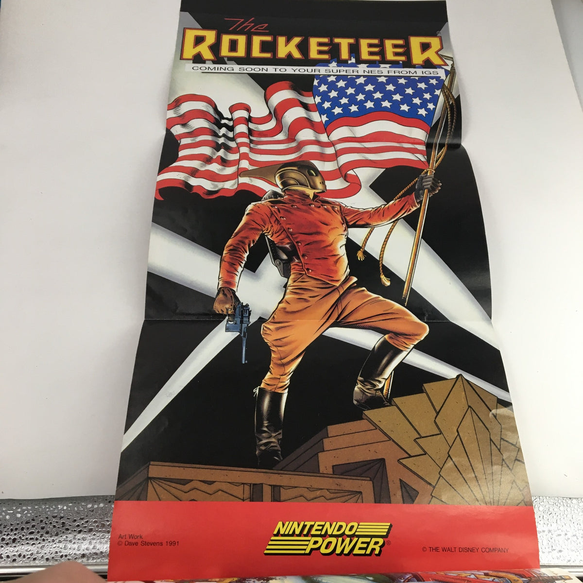 A poster from the Nintendo Power Magazine January 1992 featuring The Rocketeer, advertising an upcoming Super NES game. The image captures the character posed with an American flag.