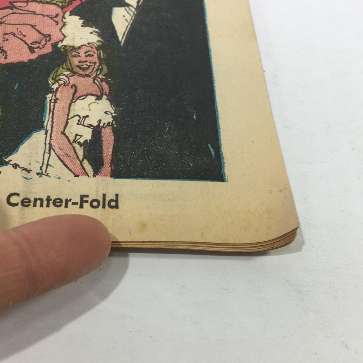 Close-up of the VTG TV Week's Complete Listings May 1-8 1971 showing the edge detail and text 'Center-Fold' with hand for scale.