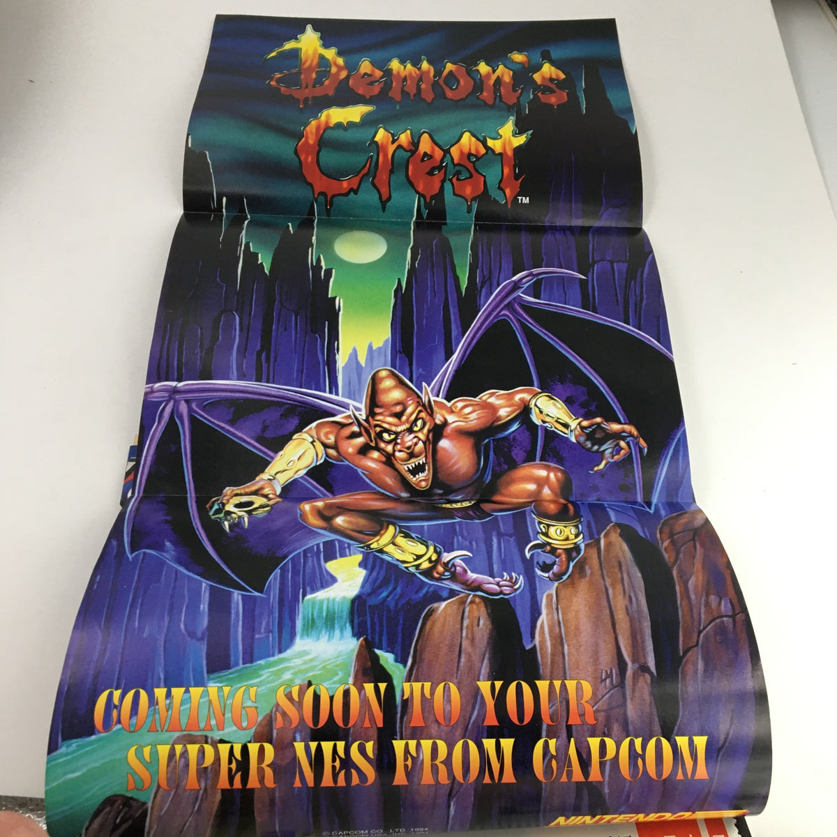 Attached poster from Nintendo Power Magazine November 1994 Vol 66 promoting Demon's Crest for Super NES, illustrated with vivid graphics and a dramatic scene.