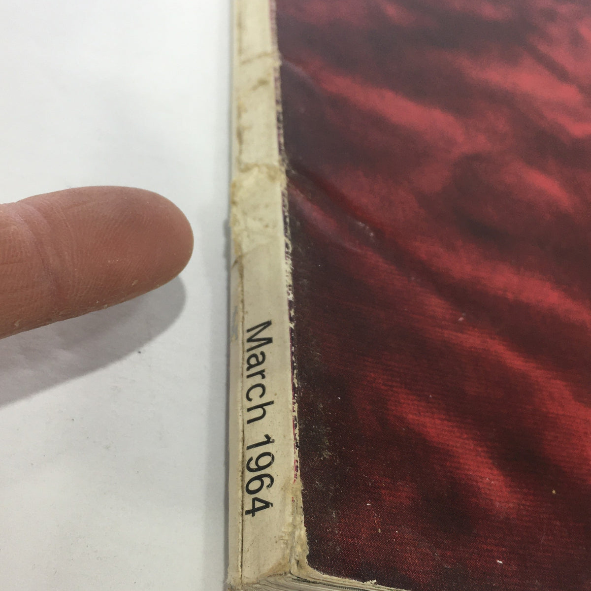 Close-up view of the spine of VTG The Connoisseur Magazine, March 1964, showcasing the publication date 'March 1964' and textured cover details.