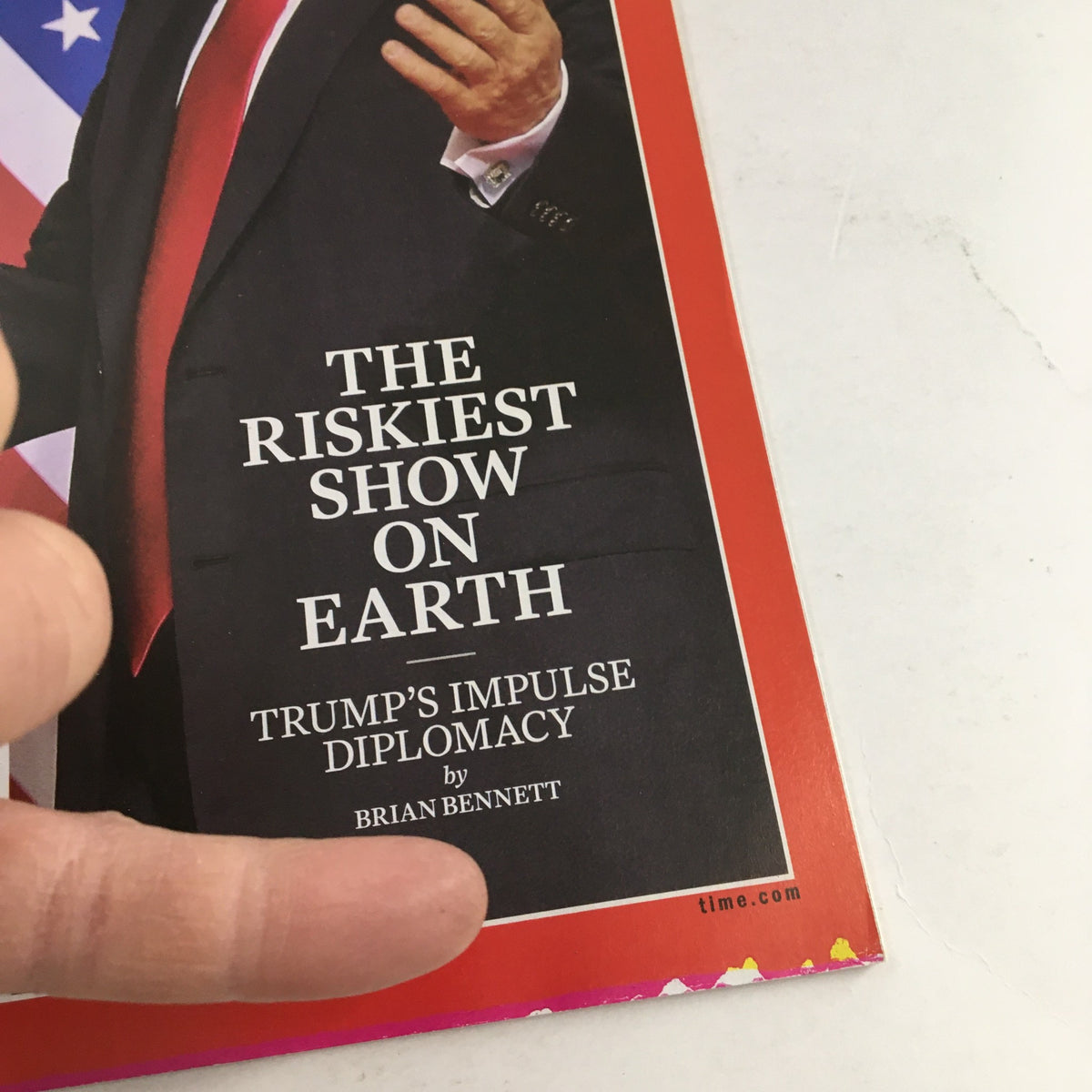 Close-up of the Time Magazine cover from June 25, 2018, focusing on the title 'The Riskiest Show on Earth' and the byline 'Trump's Impulse Diplomacy' related to the summit between Kim Jong-un and Donald Trump.