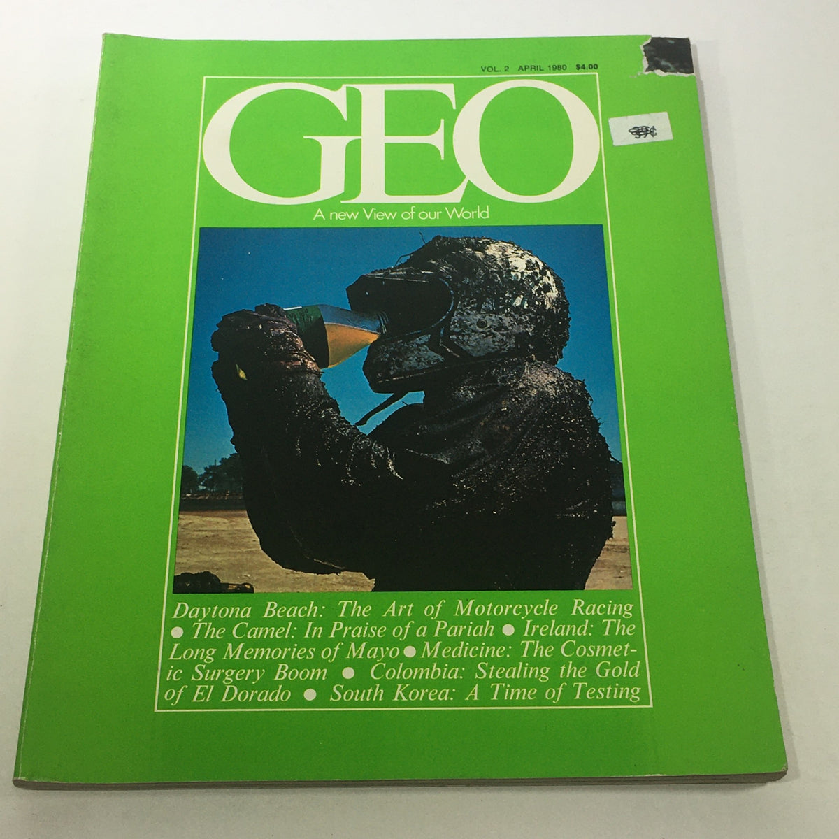 Cover of VTG Geo Magazine: April 1980 Vol. 2 - A New View Of Our World featuring a person in a motorcycle helmet drinking from a glass. The design features vibrant green colors.