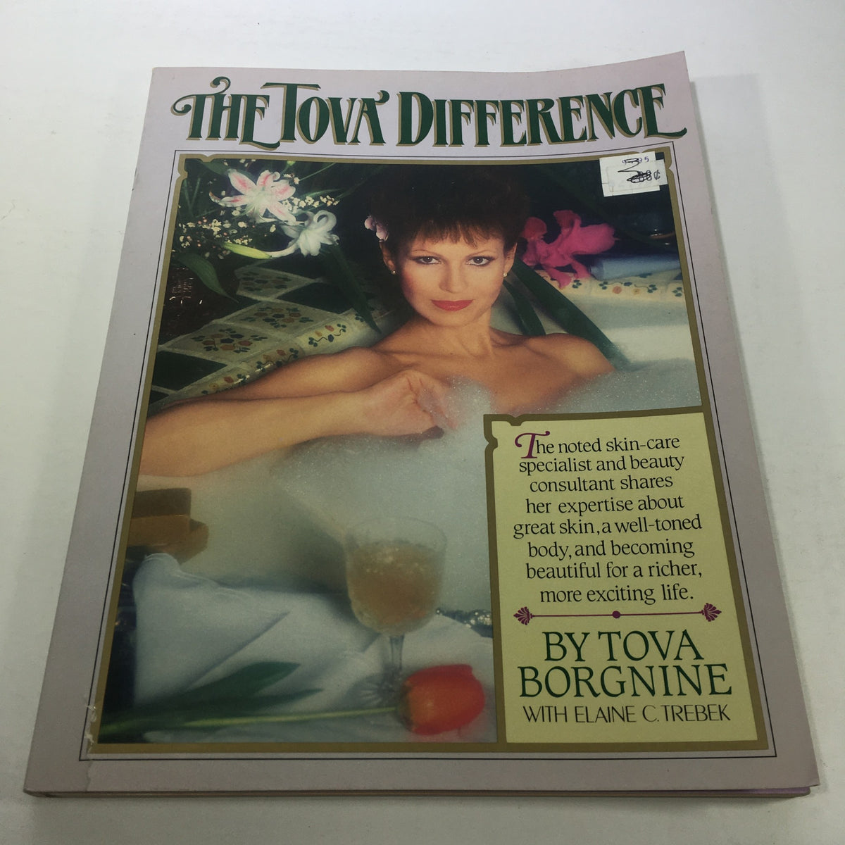 Cover of 'The Tova Difference by Tova Borgnine: 1984 - A Promise of Lasting Beauty,' featuring a stylish image of Tova Borgnine in a bubble bath, adorned with flowers and elegant decor.