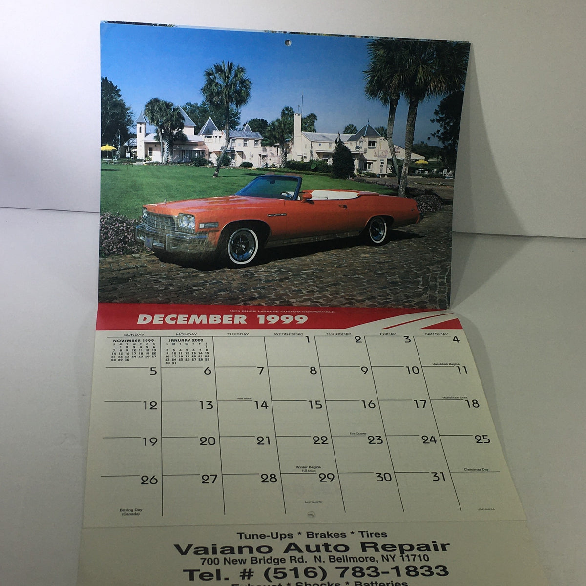 Vintage 1999 Great American Cars Vaiano Auto Repair Calendar page for December 1999 featuring a convertible parked in a scenic spot, with details of auto repair services visible.