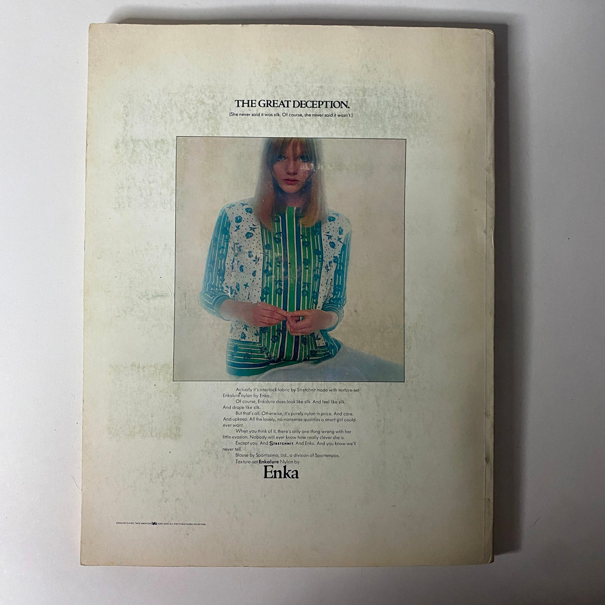 1967 American Fabrics Spring Catalog featuring the back cover with a model in a colorful knit top, promoting 'The Great Deception' for fabric from Enka, illustrating mid-century fashion and textile trends.