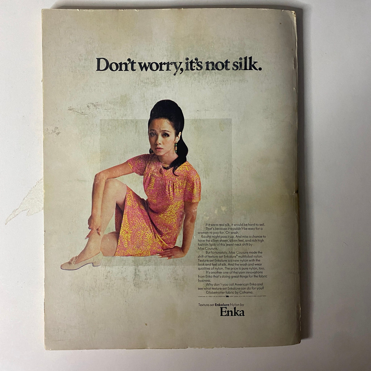 1967 American Fabrics No. 74 Winter-Spring Catalog cover showing a model in vibrant fashion, conveying the innovative spirit of the textile industry.