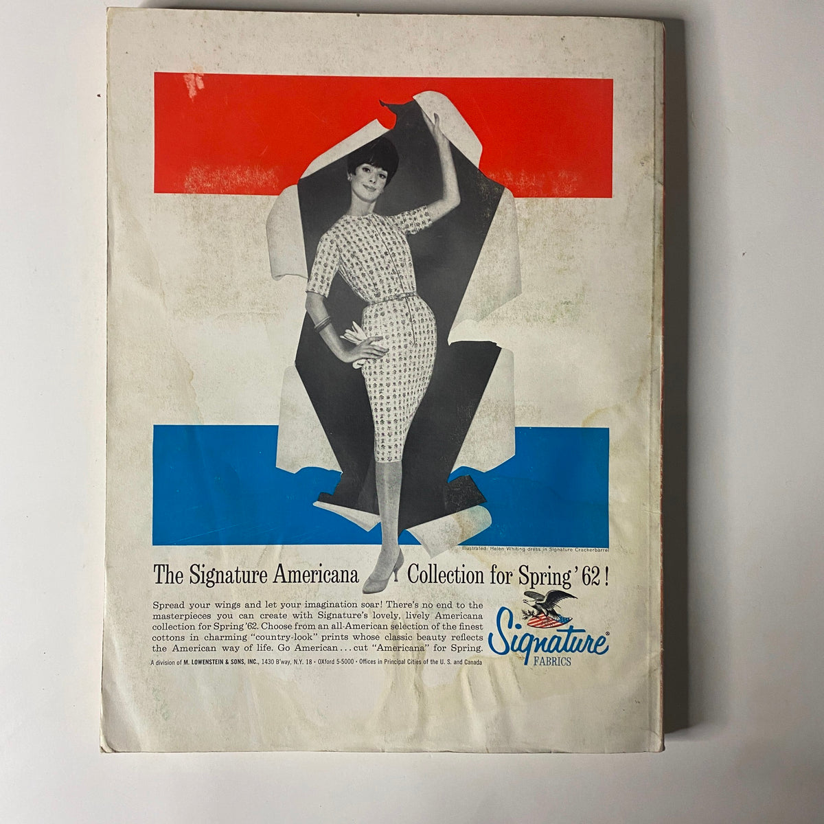 1961-1962 American Fabrics Winter Catalog featuring a vintage advertisement for the Signature Americana Collection for Spring '62, displaying a model in a stylish outfit against a colorful backdrop.