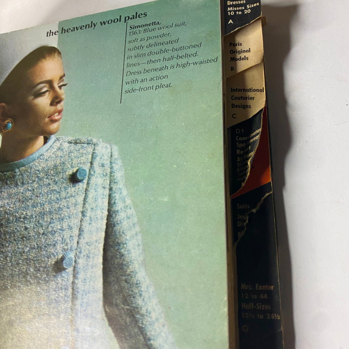 Interior detail of the 1966 Vogue Patterns April Catalog showcasing a blue wool suit sample by Simonetta with fashion details.