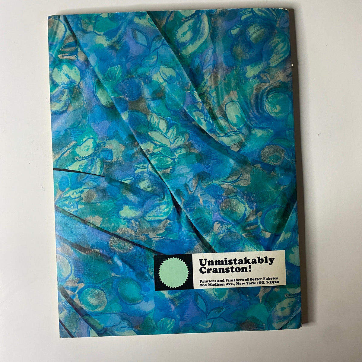 Cover of the 1964 American Fabrics No. 65 Fall Catalog presenting a vibrant floral pattern fabric, capturing the essence of textile trends from the 1960s.