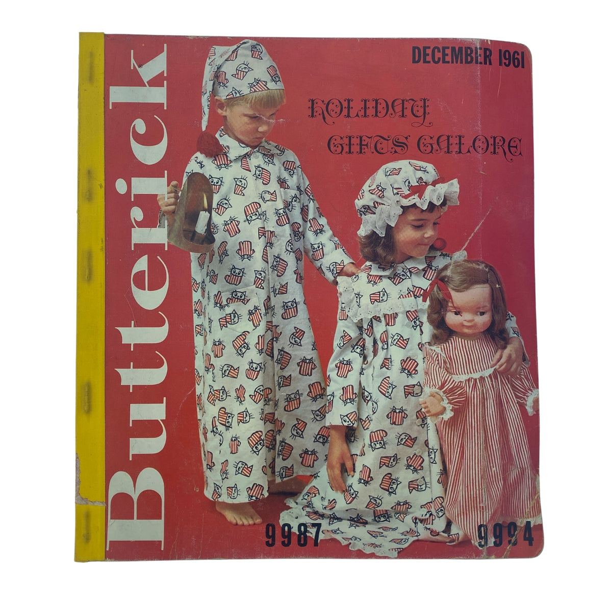 1961 December Butterick Holiday Catalog cover featuring children in festive pajama patterns, showcasing a holiday-themed sewing pattern book with the title 'Holiday Gifts Galore'.