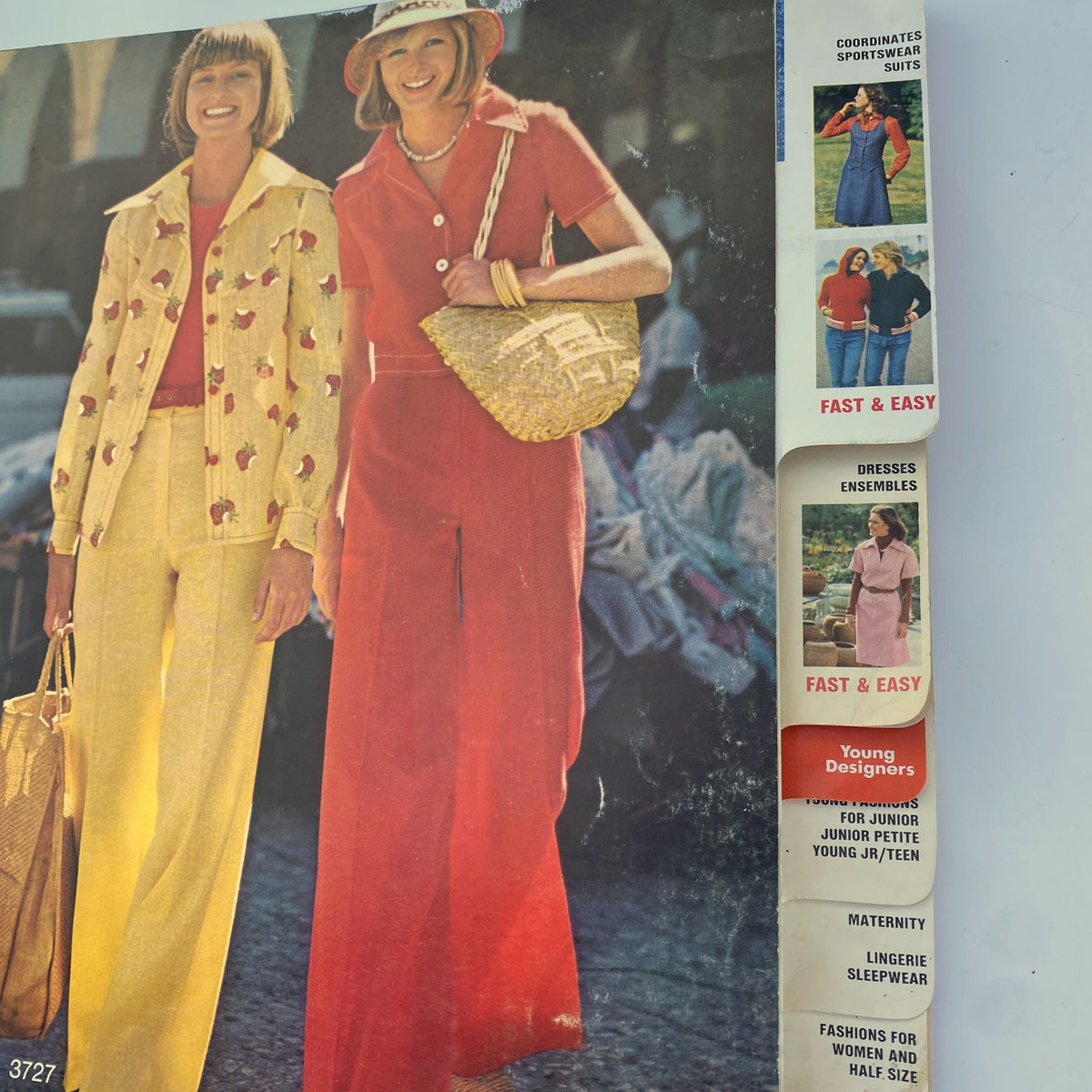 Close-up of two fashionable women from the 1974 August Butterick Catalog wearing a yellow suit and a red outfit, showcasing elegant summer fashion.