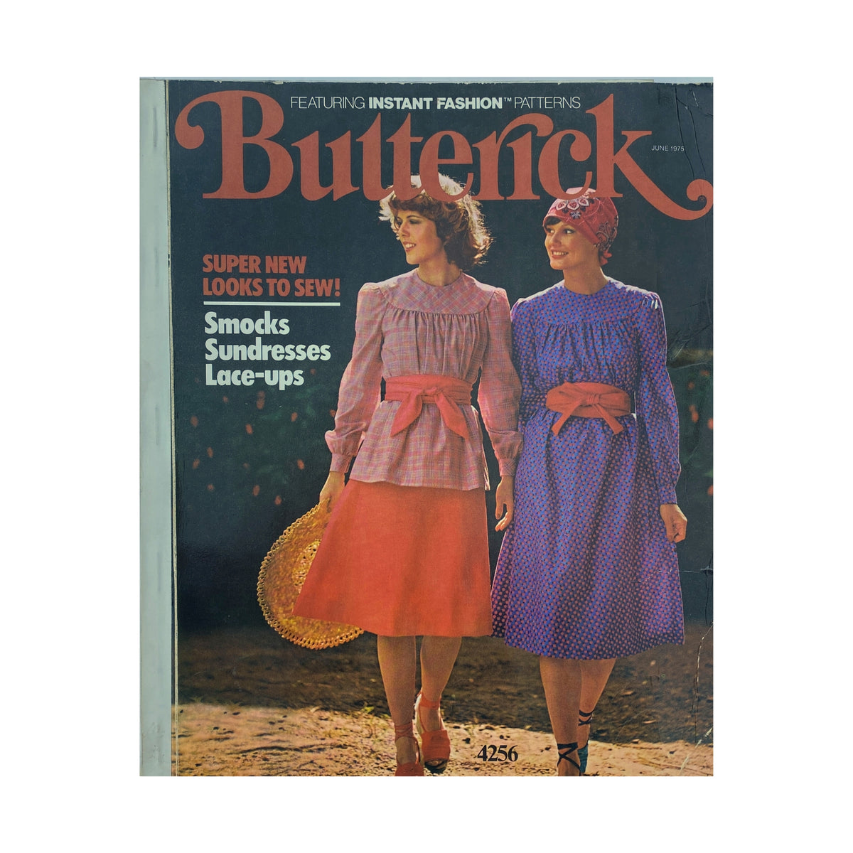 1975 June Butterick Catalog cover featuring models in colorful smocks and sundresses, showcasing DIY fashion patterns for summer styles.