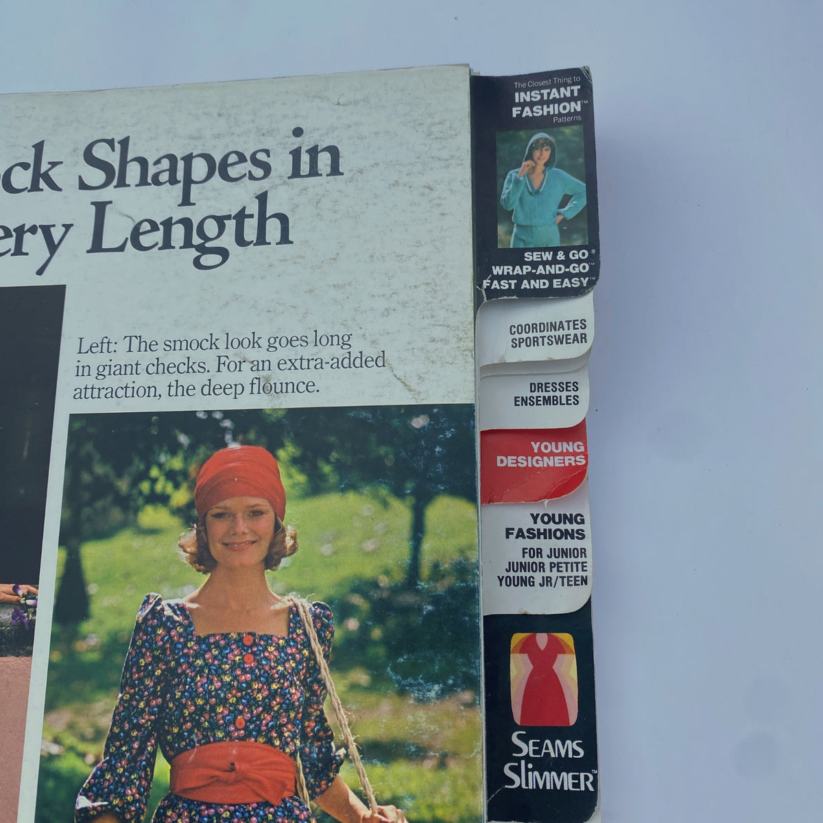 Close-up of the side of the 1975 June Butterick Catalog, showing various pattern categories including instant fashion, young designers, and sportswear.