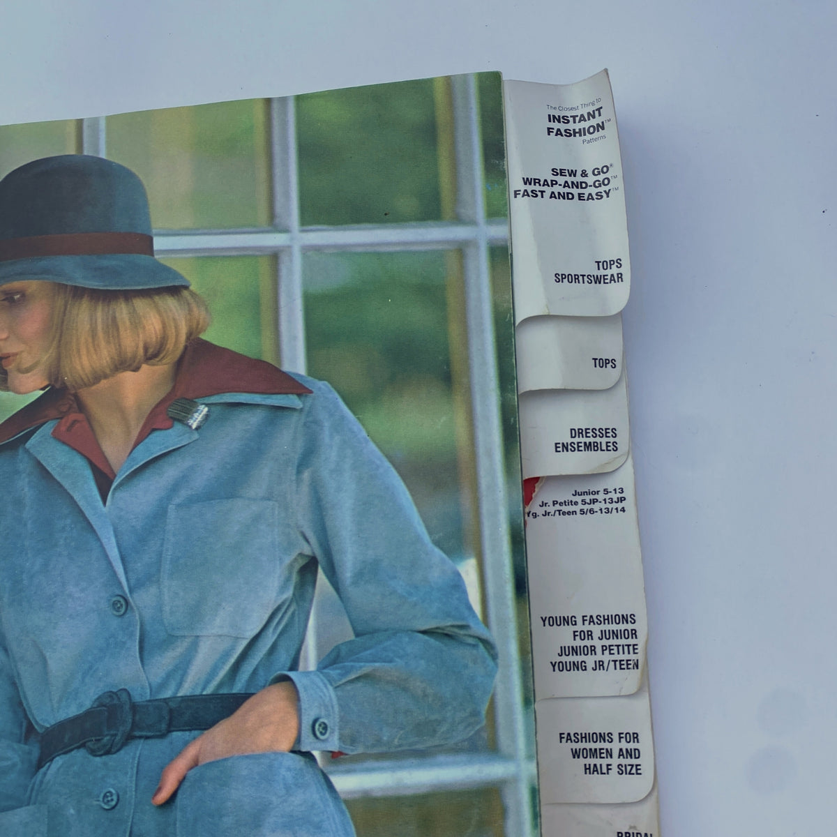 Close-up of the 1975 November Butterick Catalog's interior page highlighting instant fashion patterns for juniors and women, featuring a model in a stylish coat.