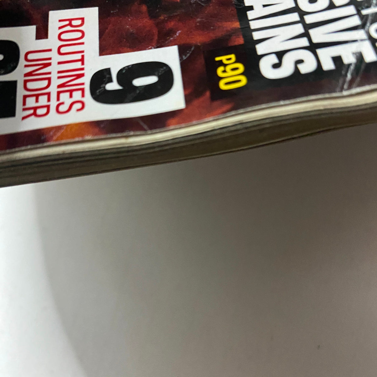 Side view of Muscle & Fitness Magazine January 2012, highlighting content on fat-burning plans and workout routines.