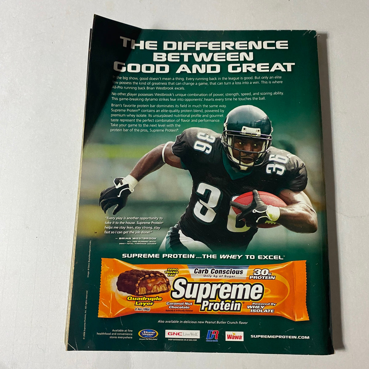 Iron Man Magazine December 2008, Vol. 67 No. 12 featuring an advertisement with NFL player Brian Westbrook promoting Supreme Protein, illustrating the difference between good and great in bodybuilding and fitness. Vintage collectible styling enhances the magazine's appeal.