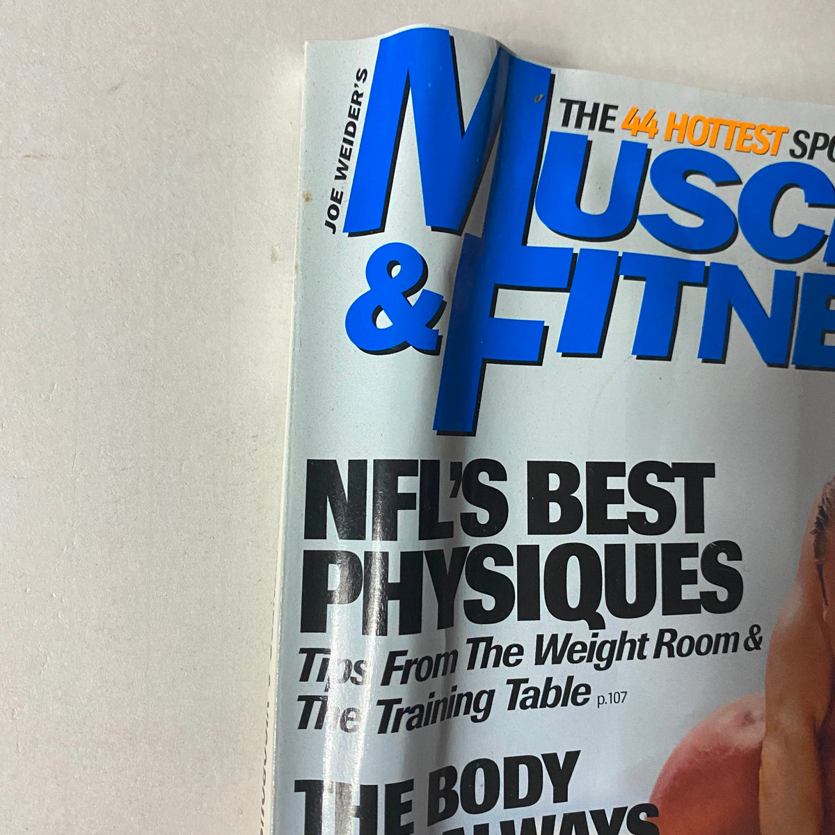 Close-up of Muscle & Fitness Magazine October 1999 cover highlighting 'NFL's Best Physiques' and workout advice, a collectible vintage magazine.